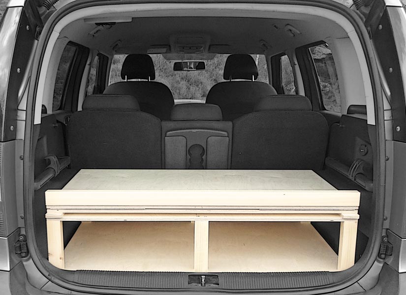 With the camper van conversion module folded in the boot of your Skoda Karoq, there is plenty of storage space underneath and on top of the module.