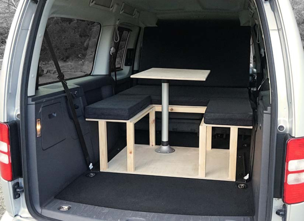 The VW Caddy Maxi Life camper van conversion in seating mode with the optional cushion set.