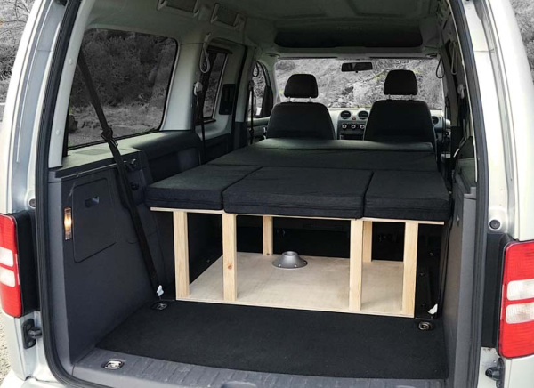 The VW Caddy Maxi Life camper van conversion in sleeping mode with the optional cushion set.